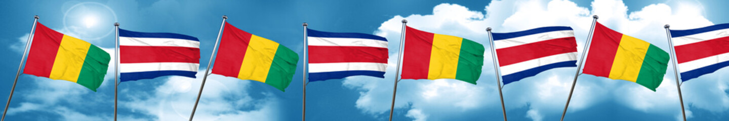 Guinea flag with Costa Rica flag, 3D rendering