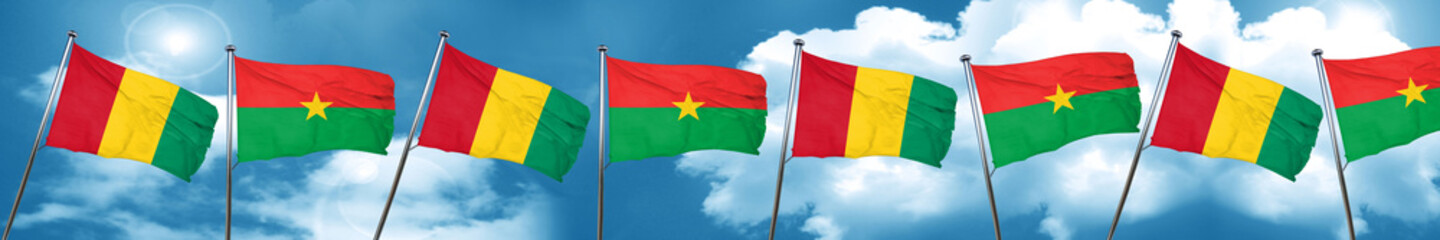 Guinea flag with Burkina Faso flag, 3D rendering