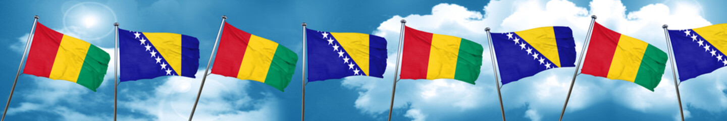 Guinea flag with Bosnia and Herzegovina flag, 3D rendering