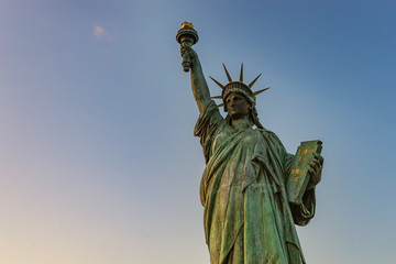 Fototapeta premium scene of Statue of Liberty on blue sky and free space for textue - can use to display or montage on product