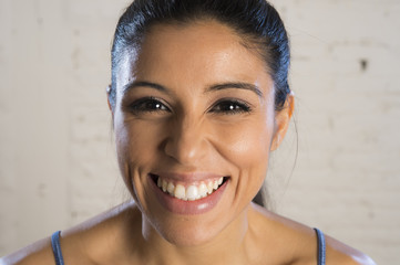 portrait of young beautiful and happy hispanic woman laughing