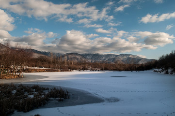 Fototapeta premium Landscape with a frozen duck lake and mountains of big Caucasus at Sheki, Azerbaijan