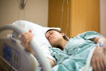 Women laying in a hospital bed prior to giving birth to a baby