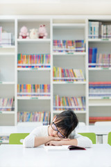 tired teenage girl napping on a book