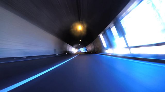 Car Drives Through An End Of An Illuminated Tunnel 4K