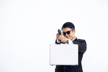 Smart man in business suit is holding short gun on white background