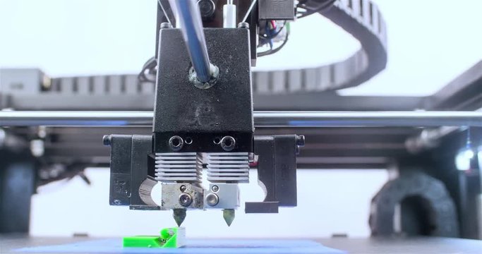 Working 3D printer 4k close-up video. Process of printing three dimensional model. Extruder creates object. Additive manufacturing device machine technology concept