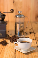Coffee cup and coffee beans on wood table