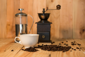 Coffee cup and coffee beans on wood table
