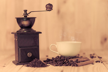 Coffee cup and coffee beans on wood table
