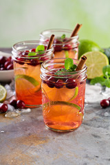 Fototapeta na wymiar Refreshing winter drink with lime and cranberry