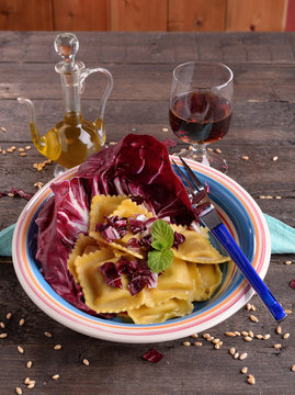 ravioli stuffed with radicchio leaf on wood by Wood