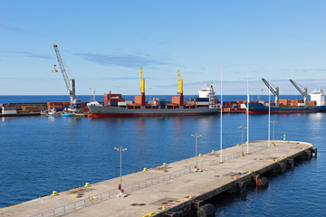 Ponta Delgada port piers, Azores, Portugal. Ocean port on a sunny morning with cargo ships.