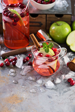 Winter refreshing cocktail with apples and cranberry