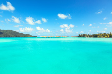 Stunning view of blue turquoise lagoon and far bungalows on back