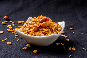 Indian fried snack, namkeen with peanuts, peas on black background