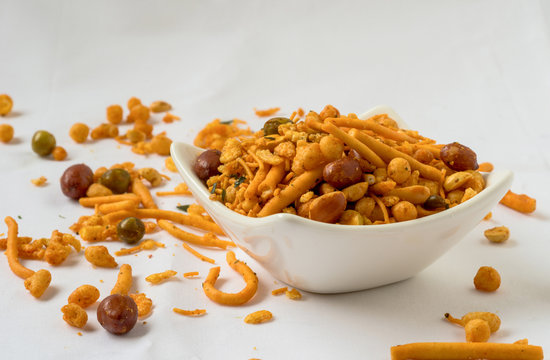 Indian fried snack, namkeen with peanuts, peas on white background