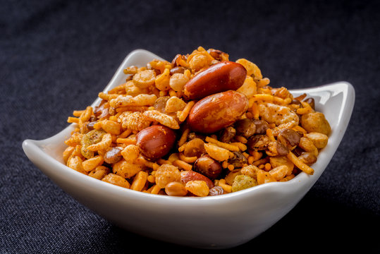 Indian fried snack, namkeen with peanuts, peas on black background