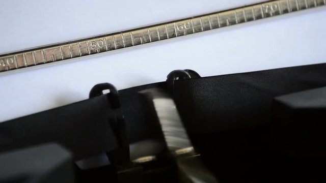 Typing the word REPORT with an old manual typewriter