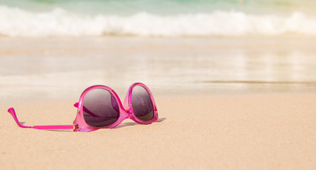 pink sunglasses on the beach
