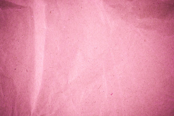 Pink crumpled recycle paper background.