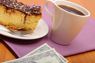 Paying for cheesecake and coffee in the cafe, finance concept