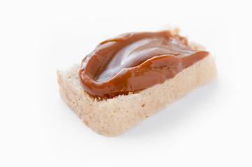 Bread with cooked condensed milk on a white background