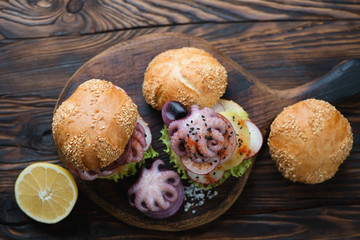 Burgers with galician style octopus in a rustic wooden setting