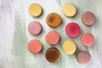 Macarons on pale whitewashed board with copyspace