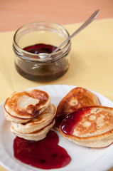 Delicious pancakes for breakfast with cherry jam