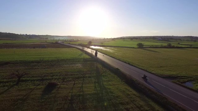 Flight on a dawn street chasing a motorcycle
Drone on the road in a fantastic sunrise