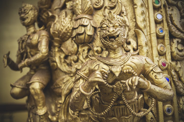 Fototapeta na wymiar Wooden creatures ornamental carvings in buddhist golden temple