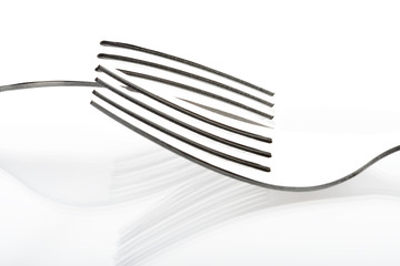 Concept with fork on white background III / The abstract concept of a simple subject
