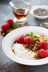 Yogurt bowl with raspberry and maple syrup
