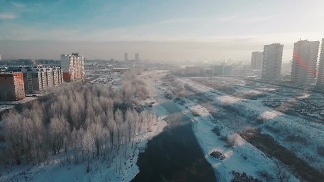 flying over the river in the winter in the city