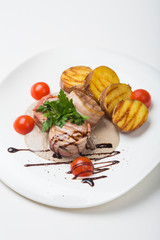 Grilled steak wrapped in bacon, with grilled vegetables