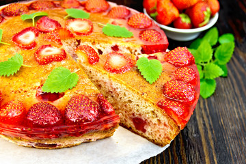 Pie strawberry with jelly on dark board