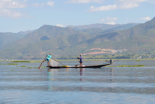 Two fishermen in the same boat. Osario, Inle Lake, Myanmar