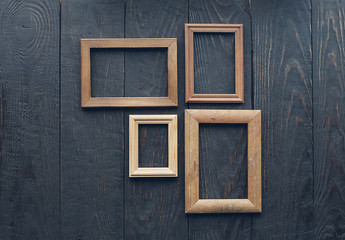 old frames on wooden wall