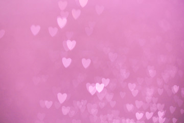 defocused lights bokeh background of pink hearts