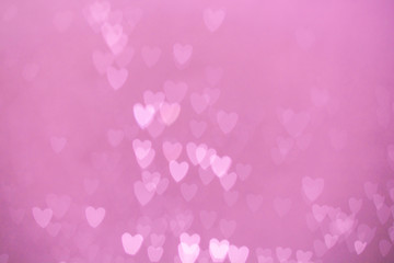 defocused lights bokeh background of pink hearts