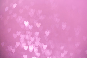 defocused lights bokeh background of pink hearts