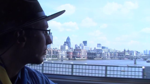 Man with hat looking out the window