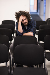 Fototapeta premium A student sits alone in a classroom