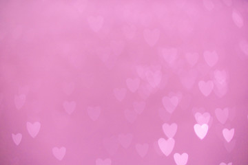 defocused lights bokeh background of pink hearts