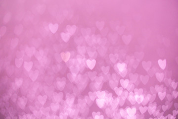 defocused lights bokeh background of pink hearts