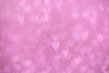 defocused lights bokeh background of pink hearts