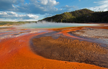 Grand Prismatic Hot Spring under sunset clouds in the Midway Geyser Basin in Yellowstone National Park in Wyoming USA