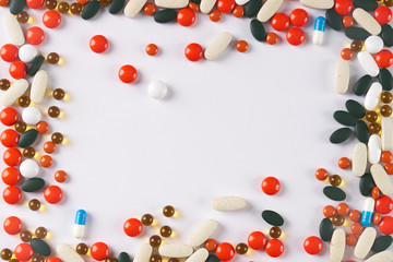 Different colored medicine and types of pills on white background. Medical health or drugs addiction concept with copy space