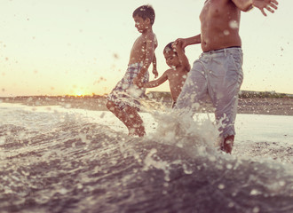 Fun kids playing splash at beach